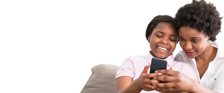 Reach Mobile - A happy mother daughter duo look at their monthly phone bill savings